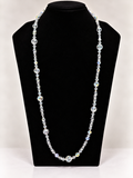 Clear iridescent crystal beaded necklace on black jewelry display